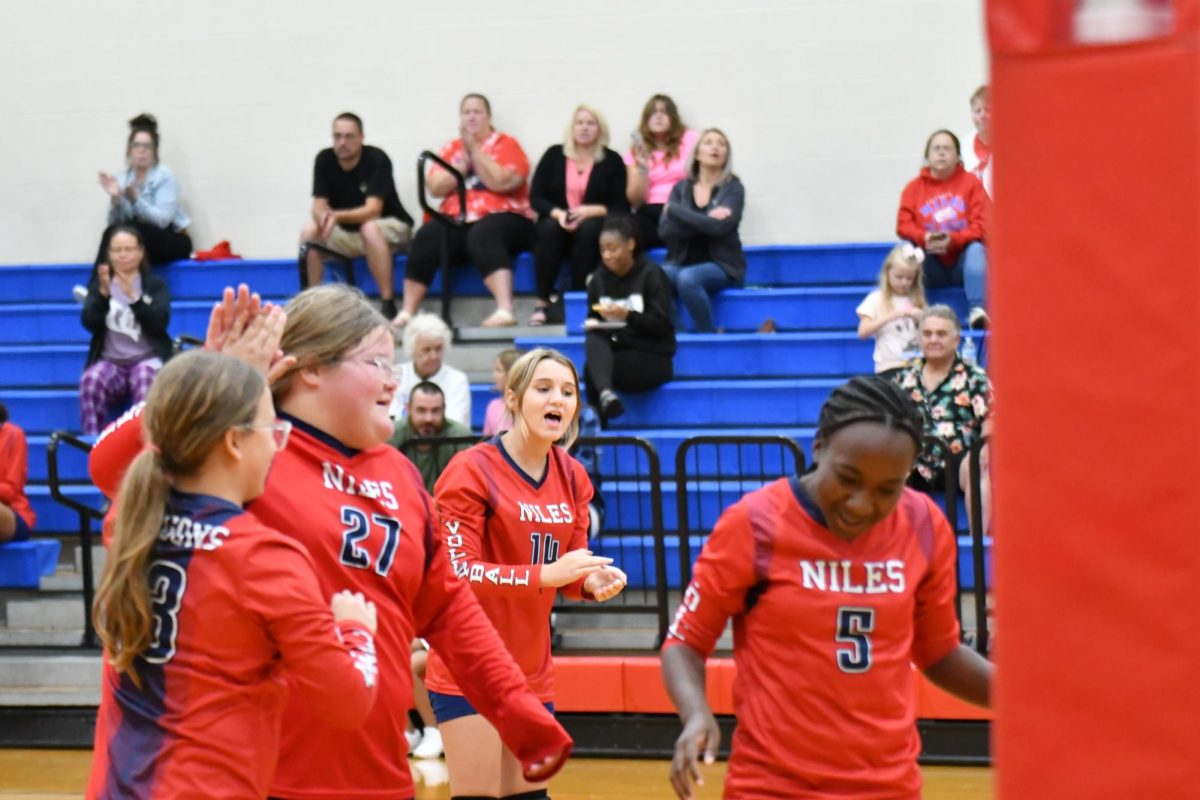 Keeley Sprague, Isabella Derr, Alyena Cunningham, and Aliyah Harris celebrating after winning the point after a hard volley!
