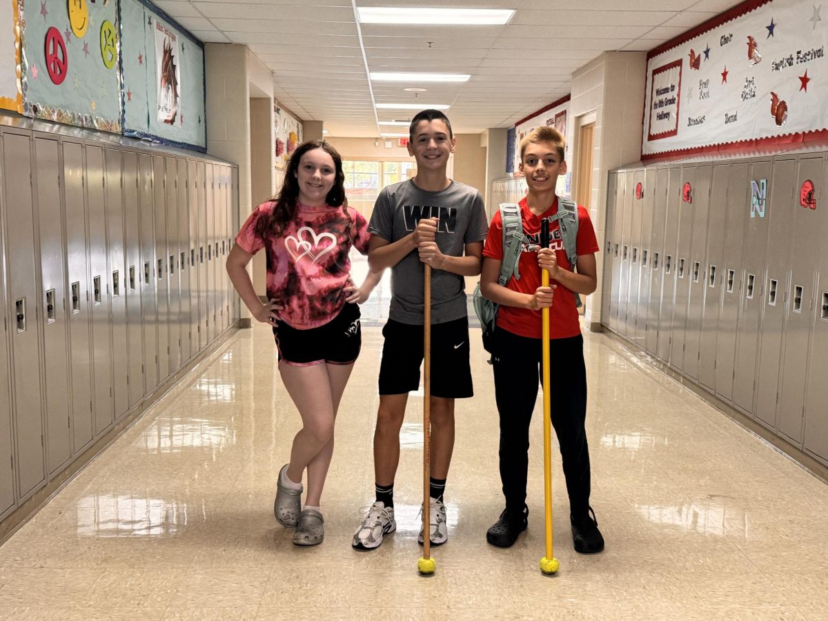 Aubrianna Newmiller, Mason Thomas, and Landon Elliott getting ready to tidy our halls!