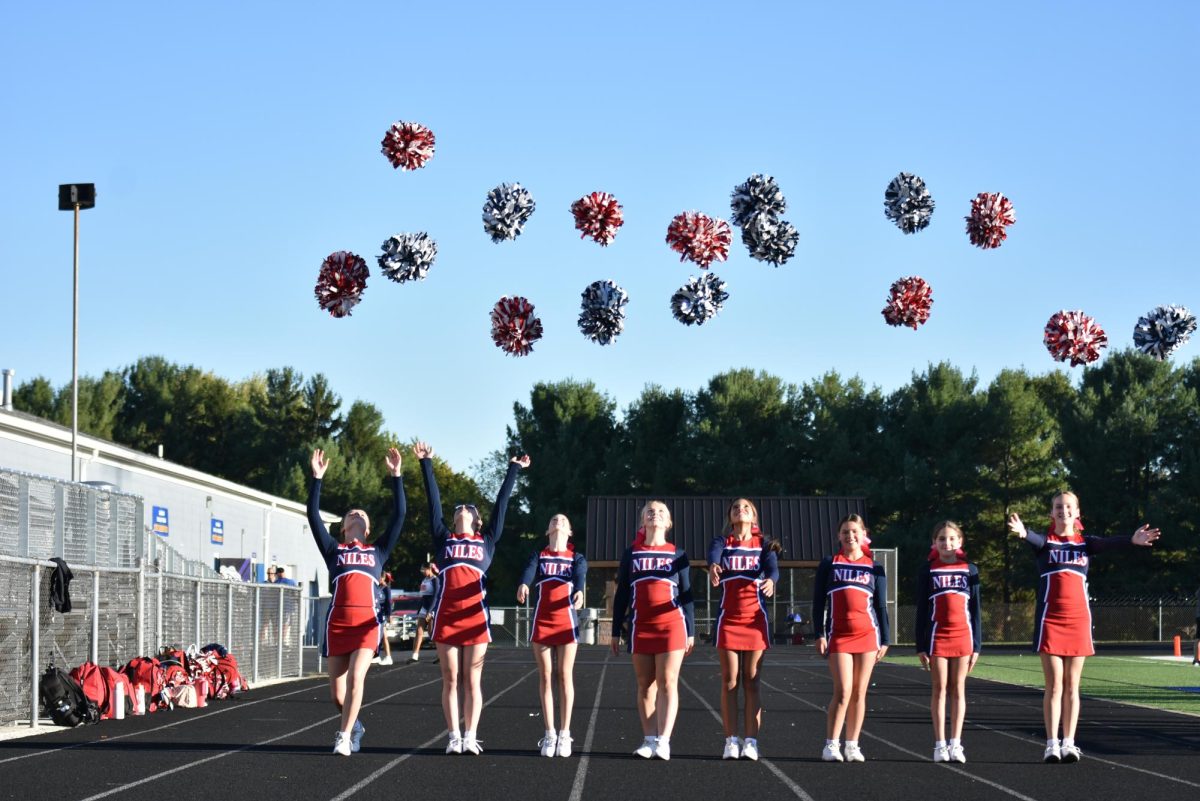 The cheerleaders throwing their pom poms in the air!