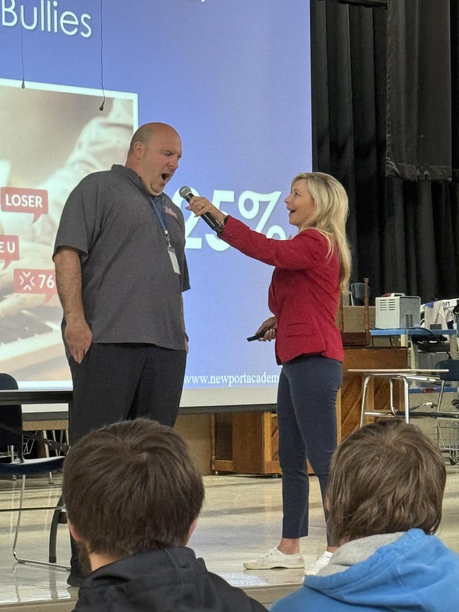 Ms. Bosley handing the microphone off to Mr. McConnell